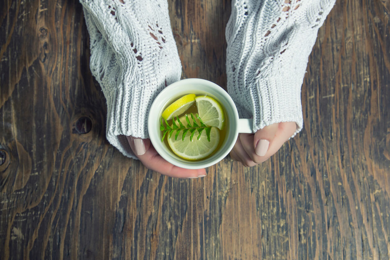Cup of tea with thyme herb and lemon slices